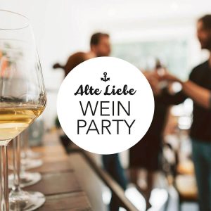 eine Gruppe von Menschen, die um einen Tisch mit Weingläsern bei Alte Liebe Catering stehen